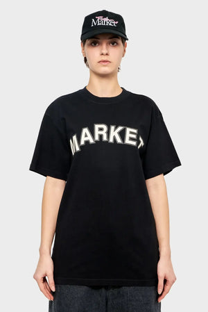 Osoba w czarnej koszulce z napisem MARKET i czapce z daszkiem, styl streetwear