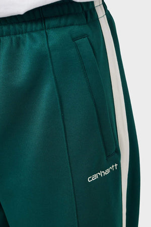 zielone spodnie dresowe z białym paskiem i logo Carhartt, detal kieszeni