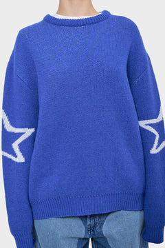 Niebieski sweter z białymi gwiazdami na rękawach, styl streetwear, denim