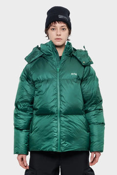 Osoba w zielonej, pikowanej kurtce zimowej z napisem 'arte', czarna czapka, styl streetwear