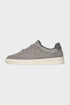 Szary sneakers zamszowy na białej podeszwie, widok z boku, minimalistyczny styl