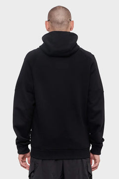 Mężczyzna w czarnej bluzie z kapturem, widok od tyłu, styl streetwear